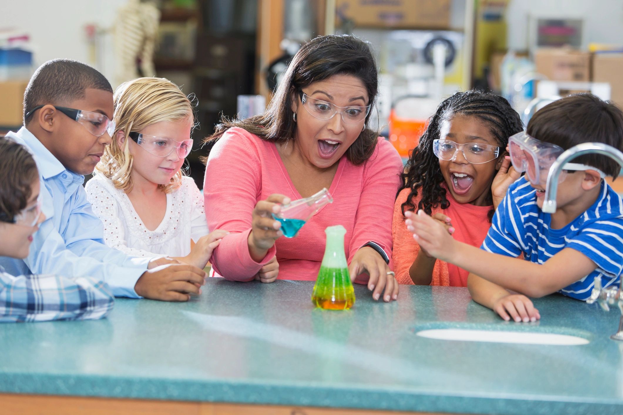 Maestra y niños trabajando en laboratorio de ciencias